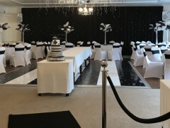 black and white backdrop with feather centrepieces