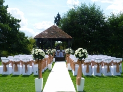 Prested hall with aisle carpet and rose trees