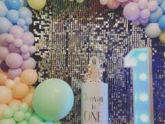 silver-sequin-wall-with-pastel-balloon-garland-and-cake-plinth